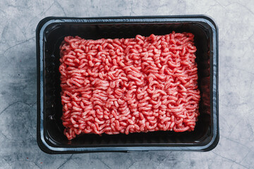 Minced meat with spices on table