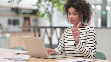 Strict African Woman with Laptop saying No by Finger Sign