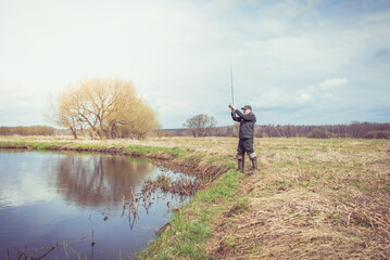 Fisherman throws a spinning rod.