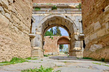 Fototapeta na wymiar One of the entrance gate of ancient city of iznik (nicaea) made of red bricks stones city walls and stairs by taken photo during sunny day and ancient architecture arch and sky low angle photo.
