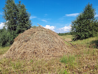 haystack and pitchfork  in the field