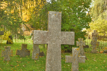 Stone crosses in the old cemetery in autumn