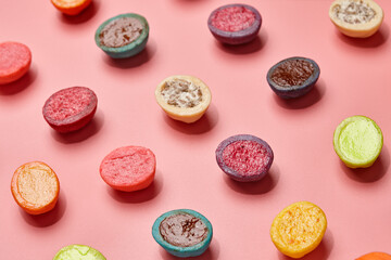 Colorful shortbread cookies with filllings on pink background