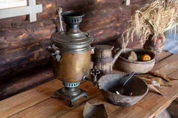 An old copper samovar on the table in a rural house.