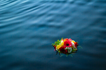Bride's bouquet, natural flowers in the blue water in the late afternoon.