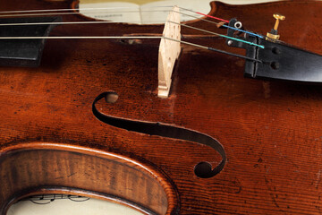 violin lies on top of the sheet music on the table, close-up