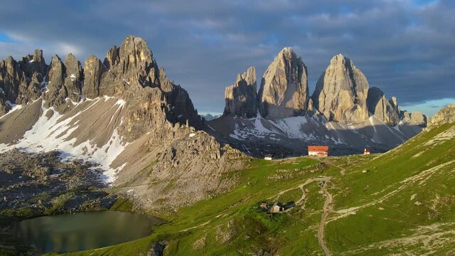 Sunrise in the National Park Tre Cime di Lavaredo with rifugio Locatelli and lake, Dolomiti Alps, South Tyrol, Italy, Europe. 4k drone video. 60fps