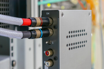 The AV cables are connected to a digital amplifier. The digital signal converter is in the rack....