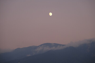 Full moon on the mountain of grand (uludag, bursa) during night with mist and fog on the mountain peak