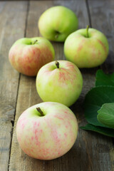 Ripe garden apples on wooden background. Selective focus