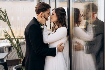 Wedding day. Stylish european wedding couple hugging and looking at each other.