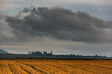 Fototapeta premium The sky with storm clouds over the village. Summer rural landscape.