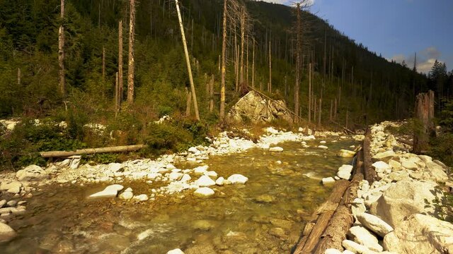 Mountain stream with crystal clear water and small cascade in Tatra Mountains, Poland. Hiking trails on the way to Morkie oko