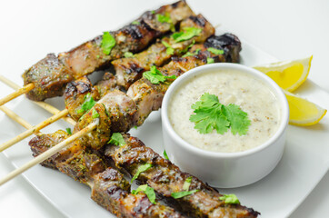 Pork shoulder kebabs with a lemon and herb rub and a garlic and mint yogurt sauce