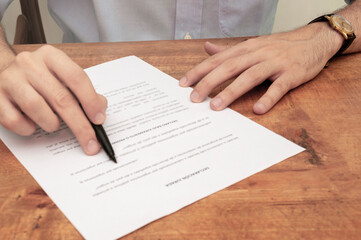 Businessman checking agreement before signing.
