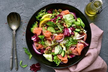Fresh vegetable salad with salted salmon. Top view with copy space.