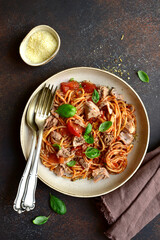 Italian pasta spaghetti with tuna in tomato sauce. Top view with copy space.