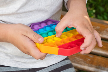 child playing with colorful educational toy simple dimple.