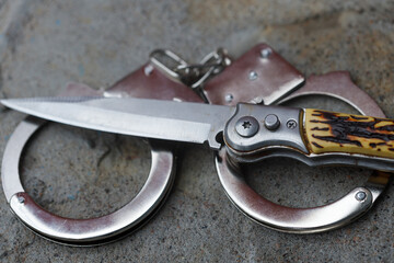 the knife is handcuffed. crime concept