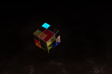 Colorful bright glass prism cube  Refracting light in vivid rainbow colors.