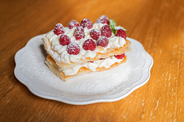 French slavdlka pastries milfey cake with cream and shortcakes and raspberries in a restaurant