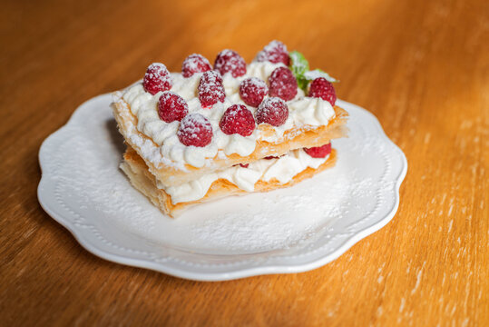 French slavdlka pastries milfey cake with cream and shortcakes and raspberries in a restaurant