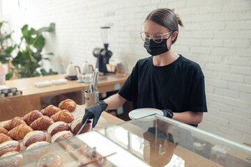 Female person in medical protective mask and gloves