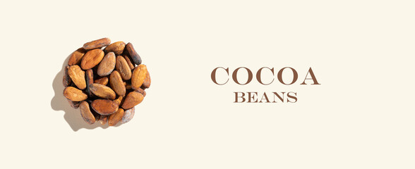 Creative composition with healthy ingredient organic cocoa beans products on a ivory background....