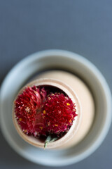 Gomphrena globosa or globe amaranth inside a wooden vase