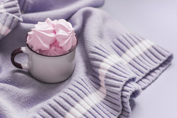 Airy pink marshmallows in a cup on a lilac background. Trending color, copy space.