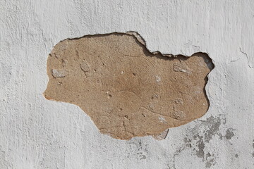 hole in the white plaster