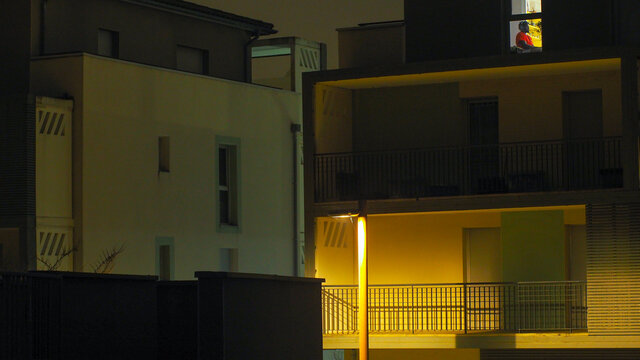 Appartements dans le centre-ville de Balma, illuminés par une douce lumière orangée, à la tombée de la nuit