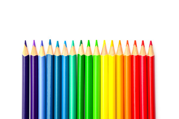 Colored pencils are isolated on a yellow background at the bottom. A rainbow made of pencils. Drawing office. School supplies. Back to school. Pattern. Artist's tool. P