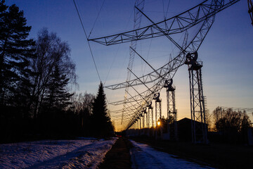 Antenna Array. A long row of radio telescopic antennas at the sunset