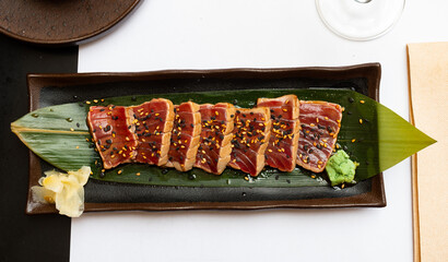 Japanese tuna sashimi tataki on green leaf