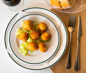 Appetizing deep fried salt cod croquettes Bunuelos de bacalao made from codfish with flour and eggs...