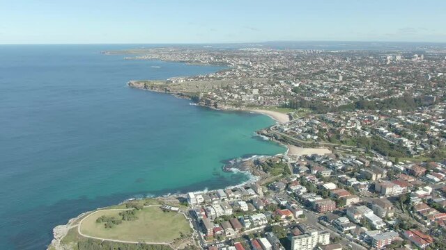 A aerial shot over rock pools to reveal Tamarama Beach. Sydney Australia.Aerial Drone Shot of Suburban Beach Coastline In Sydney Australia, Tamarama, Bronte Beach, Eastern Suburbs.
