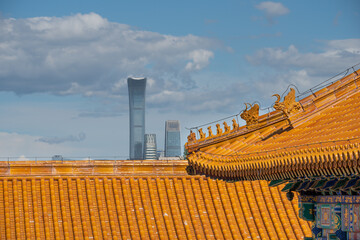 Immortal and beasts on the eaves of the building in Forbidden City against the highest skyscraper- China Zun in Beijing