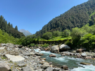Beautiful green mountains and Uhl river flowing in Thamsar mountain trek, himachal pradesh, India