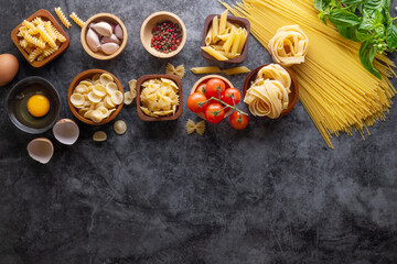 Mixed dried pasta selection on stone background