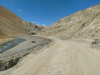 Beautiful leh ladakh region, dirt road and river on left side at very high altitude