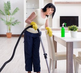 Senior old woman tired after vacuum cleaning house