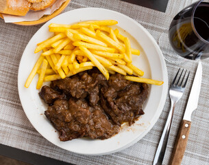 Image of the delicious stewed veal with sauce, served with French fries