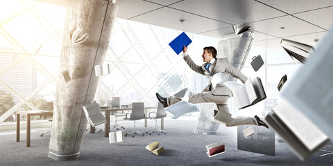 Businessman running among chaos . Mixed media . Mixed media
