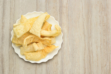 Top View Cow Skin Cracker, Krupuk Kulit, Javanese : Rambak or Minangkabau: Karupuak Jangek is a Traditional Indonesian Cattle Skin Cracker. Made from Soft Inner Skin of Cattle (Cow or Water Buffalo