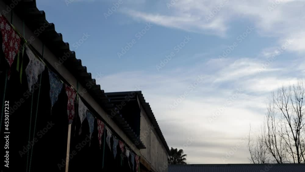 Wall mural timelapse of clouds and playground flags