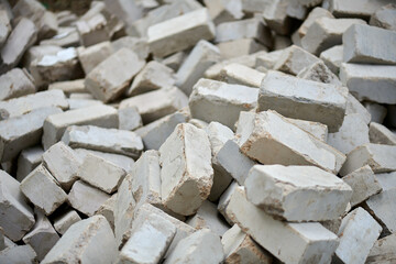 a dump of damaged gray bricks on the ruins