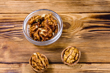 Cores of walnut in glass bowl on a wooden table