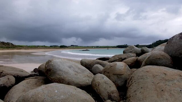 Stunning rounded boulders on the beach at unique landscape of Matai Bay on Karikari Peninsula in North Island, New Zealand Aotearoa. Moody cloudy day on the beach.