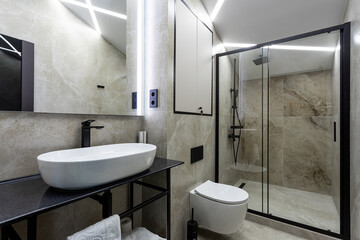 Bathroom in a traditional style with brown and gray walls.Minimalist shower room with hotel sauna